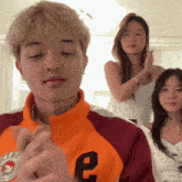 a man in an orange jacket with the letter e on it