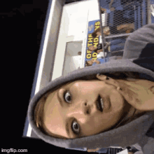 a girl wearing a hoodie is standing in front of a sign that says of the indians
