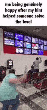 a man is dancing in front of a wall of televisions while someone solves the level of a game .