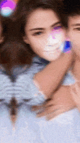 a blurry picture of a man and woman hugging