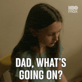 a girl sitting in a chair with the words dad what 's going on behind her