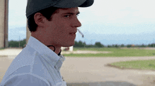 a man wearing a baseball cap and white shirt