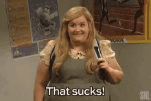 a woman is holding a backpack and says that sucks .