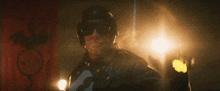 a man wearing a helmet and goggles holds up his hand