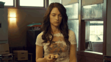 a woman wearing a t-shirt that says ' hawaii ' on the front