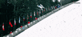 a person is skiing down a snow covered slope with flags in the background and a watermark that says levanartz