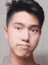 a close up of a man 's face with a slight smirk on his face