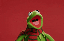 kermit the frog wearing a scarf with his tongue hanging out