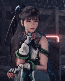 a girl with a ponytail is wearing a glove that says tnt