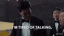 a man in a tuxedo is tired of talking