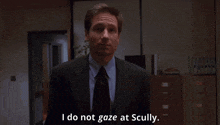 a man in a suit and tie says that he does not gaze at scully