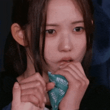 a woman is covering her mouth with a bandana that says ' a ' on it
