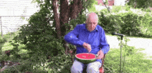 an elderly man is sitting in a chair eating a watermelon