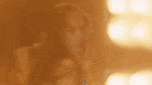 a woman is standing in front of a mirror in a room with a lot of lights .