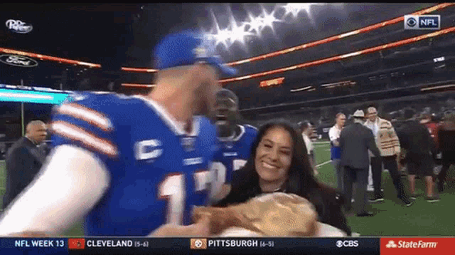 Josh Allen of the Buffalo Bills eats a turkey leg while he walks off