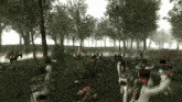 a group of soldiers are fighting in a forest with a man on a horse in the background