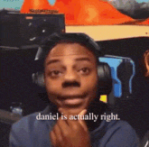 a man is wearing headphones and making a funny face .