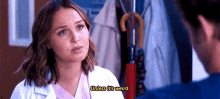 a woman in a lab coat is talking to a man and says " unless it 's weird " .