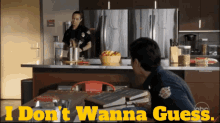 a man sitting at a table with the words " i don 't wanna guess " on the bottom