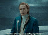 a woman in a blue jacket says the loss of an objective reality perhaps