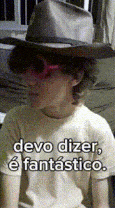a person wearing a cowboy hat and sunglasses says devo dizer
