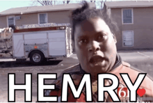 a man standing in front of a fire truck with the word hemry written on it