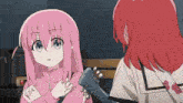 a girl with pink hair is holding a guitar