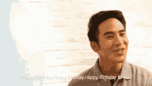a man with a balloon in front of his head says happy birthday