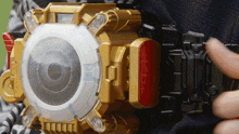 a person is holding a toy that looks like a camera with a circle in the middle