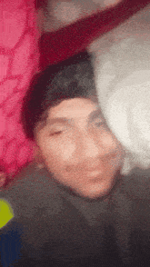 a blurry picture of a man 's face with his eyes closed
