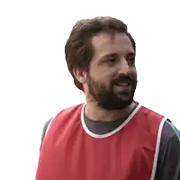 a man with a beard wearing a red vest is smiling