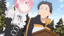 a man and a woman are standing next to each other in a forest