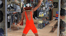 a man in an orange jumpsuit with the number 9 on his face