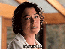 a woman says " i 'm sorry bill " in front of a window