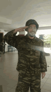 a man in a military uniform salutes while a woman stands behind him