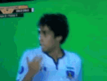 a soccer player wearing a number 10 jersey covers his face with his hands
