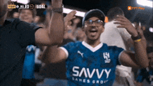 a man wearing a blue shirt with the word savvy on it