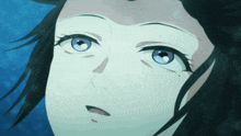 a close up of a woman 's face with blue eyes and black hair