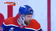 a hockey player wearing a blue helmet with the number 25 on it