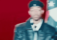 a blurry picture of a man wearing a hat and a jacket with the letter z on it