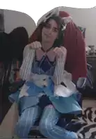 a girl in a blue and white dress with a cat ear on her head