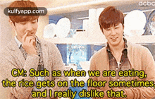 two men are standing next to each other in a kitchen and one of them is eating rice on the floor sometimes .