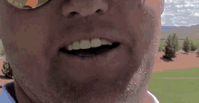 a close up of a man 's face with water coming out of his mouth .
