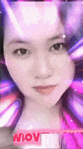 a woman 's face is surrounded by purple lights and the word wow is on the bottom right