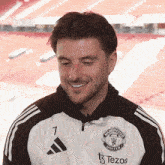 a man wearing a manchester united jacket with the number 7 on it