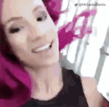 a close up of a woman 's face with a pink pillow on her head .