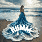 a woman in a long blue dress is standing on a beach