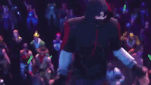 a group of dancers are performing on a stage with a cake in the middle