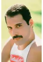 a man with a mustache is wearing a white tank top that says peterbilt on it