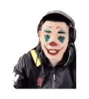a man wearing a clown mask and headphones is looking at the camera .